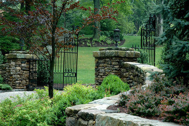 Design ideas for a large traditional front yard stone landscaping in New York.