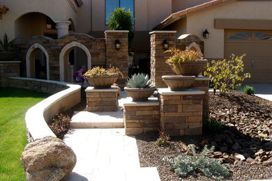 Inspiration for a mid-sized drought-tolerant and partial sun front yard concrete paver landscaping in Phoenix.