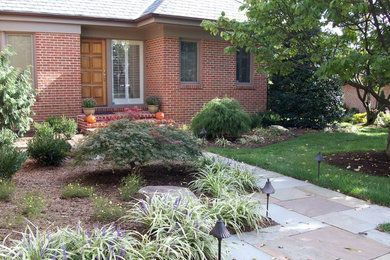 Inspiration for a mid-sized transitional partial sun front yard stone garden path in Baltimore.