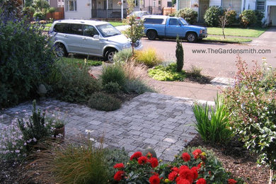 Design ideas for a small traditional full sun hillside concrete paver garden path in Portland.