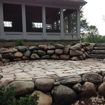 Extended flagstone patio with boulder wall