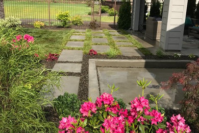 Design ideas for a medium sized contemporary back partial sun garden for summer in Boise with a garden path and concrete paving.