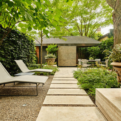 Design ideas for a small contemporary partial sun backyard stone landscaping in Toronto for spring.