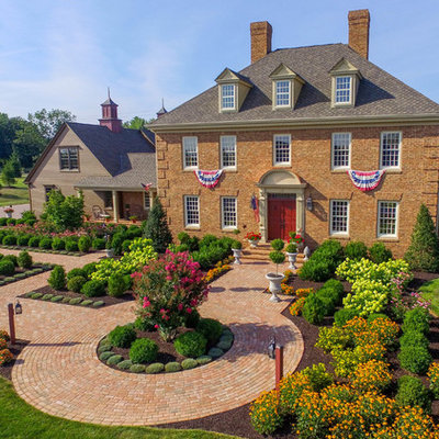 Inspiration for a huge traditional full sun front yard brick landscaping in Philadelphia.