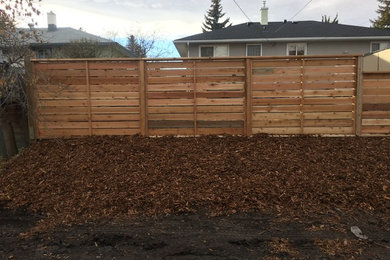 This is an example of a mid-sized modern backyard landscaping in Calgary.