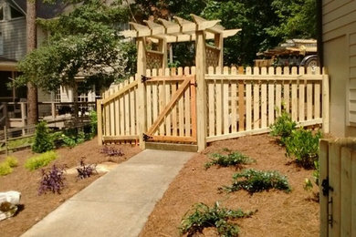 Inspiration for a mid-sized farmhouse partial sun side yard mulch formal garden in Atlanta.