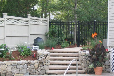 Photo of a backyard stone landscaping in Boston.