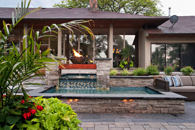 Photo of a transitional backyard concrete paver water fountain landscape in Toronto.