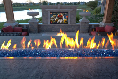 Inspiration for a traditional full sun backyard brick landscaping in Chicago with a fire pit for summer.