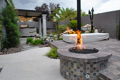 Inspiration for a mid-sized traditional backyard concrete paver landscaping in Las Vegas with a fire pit.