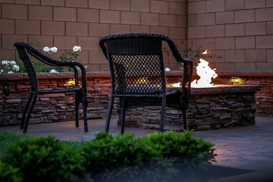 Design ideas for a mid-sized traditional full sun backyard brick landscaping in Los Angeles with a fire pit for spring.
