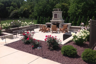 This is an example of a mid-sized traditional full sun backyard concrete paver landscaping in Chicago with a fire pit.