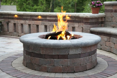 Inspiration for a mid-sized contemporary courtyard brick patio remodel in Detroit with a fire pit