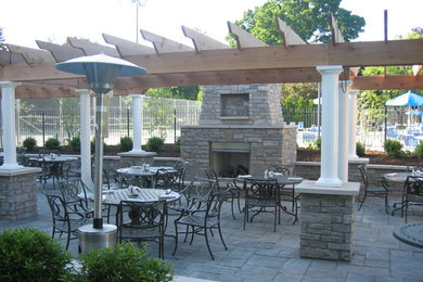 Example of a large backyard brick patio design in Chicago with a fire pit