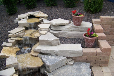 This is an example of a traditional backyard water fountain landscape in Chicago.