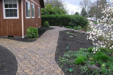 This is an example of a small contemporary full sun side yard mulch garden path in Portland.