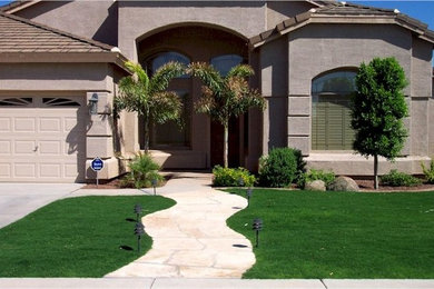 Design ideas for a mid-sized traditional partial sun front yard stone driveway in Phoenix.