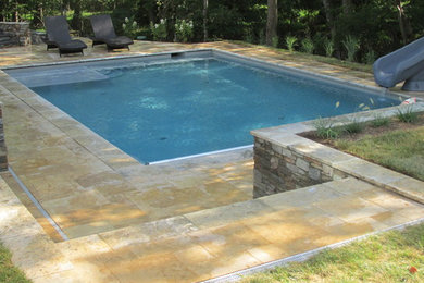Imagen de piscina contemporánea de tamaño medio rectangular en patio trasero con adoquines de piedra natural