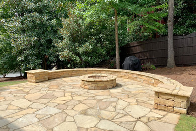 Example of a mid-sized mountain style backyard stone patio design in Atlanta with a fire pit