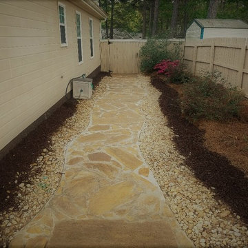 flagstone walkway with new fence and landscape