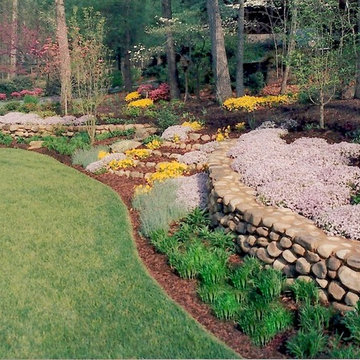 Flowing stone walls in front yard woodland provide curb appeal