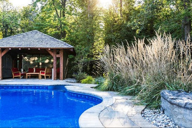 Inspiration for a mid-sized rustic partial sun backyard concrete paver landscaping in Ottawa for spring.