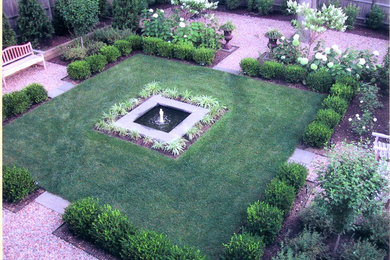 Photo of a traditional partial sun backyard gravel formal garden in Providence.