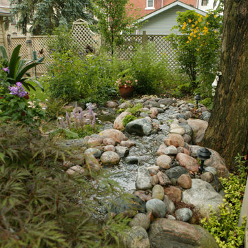 Formal Gardens in Front and Pondless Stream in Backyard