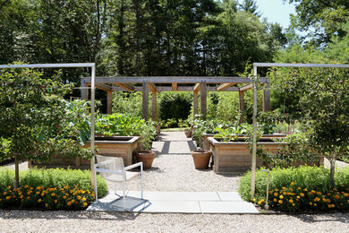 This is an example of a farmhouse full sun backyard gravel landscaping in Boston for summer.
