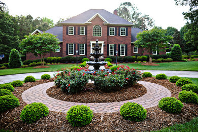 Photo of a mid-sized contemporary full sun front yard concrete paver landscaping in Charlotte for summer.