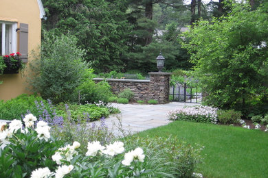 Photo of a mid-sized french country shade backyard concrete paver formal garden in Manchester for spring.