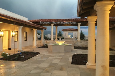 Inspiration for a large timeless courtyard stone patio fountain remodel in Albuquerque