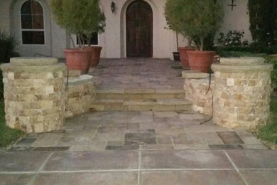 Inspiration for a mediterranean front formal garden in Los Angeles with natural stone paving.