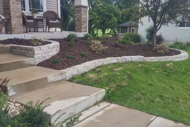 Design ideas for a large traditional drought-tolerant and partial sun front yard mulch landscaping in Minneapolis.