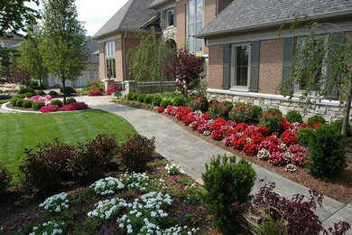 Photo of a medium sized classic front formal partial sun garden for summer in Cincinnati with a garden path and concrete paving.