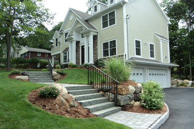 Design ideas for a traditional front yard stone landscaping in New York.