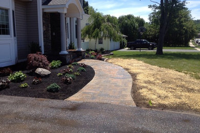 Inspiration for a mid-sized contemporary partial sun front yard brick landscaping in Bridgeport for spring.