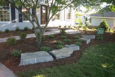This is an example of a small partial sun front yard concrete paver landscaping in Grand Rapids.