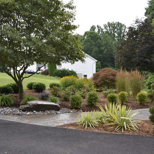 This is an example of a large traditional backyard partial sun garden for spring in DC Metro with a garden path and natural stone pavers.