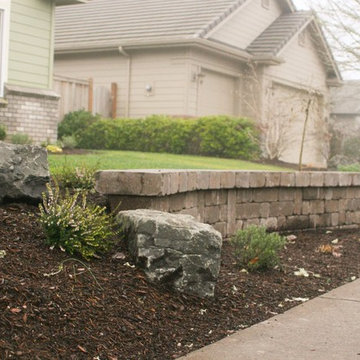 Front yard retaining wall with ornamental boulders