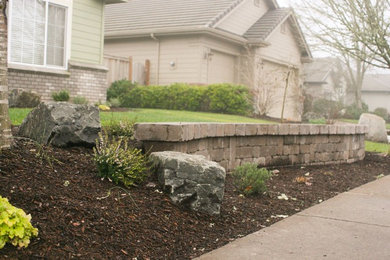 This is an example of a mid-sized craftsman front yard retaining wall landscape in Other for winter.