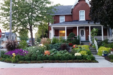 This is an example of a mid-sized transitional full sun front yard vegetable garden landscape in Toronto for fall.