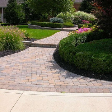 Front yard with landscaping, walkway, and retaining walls