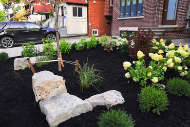 This is an example of a small contemporary full sun concrete paver landscaping in Toronto.