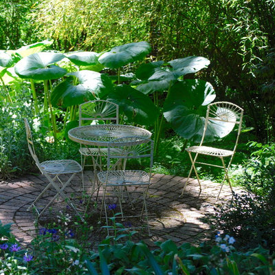 Inspiration for a mid-sized eclectic shade backyard brick formal garden in Seattle for summer.