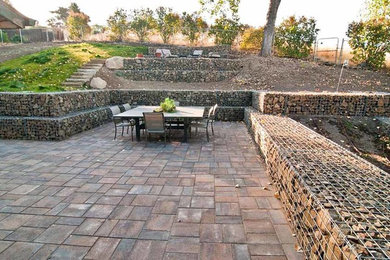 Example of a mid-sized trendy backyard concrete paver patio design in Boise