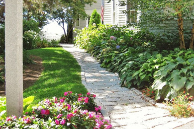 Photo of a mid-sized coastal partial sun front yard stone garden path in Portland Maine for summer.