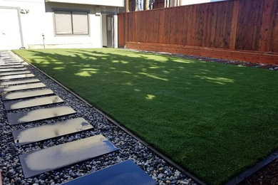 Photo of a mid-sized contemporary partial sun backyard concrete paver landscaping in San Francisco for spring.