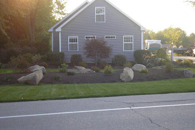 This is an example of a mid-sized drought-tolerant and shade side yard mulch landscaping in Portland Maine.