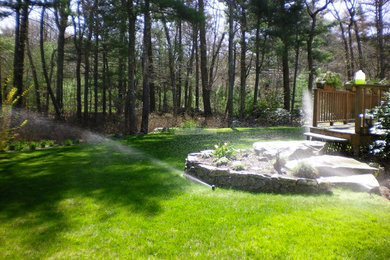 Inspiration for a backyard stone landscaping in Providence.